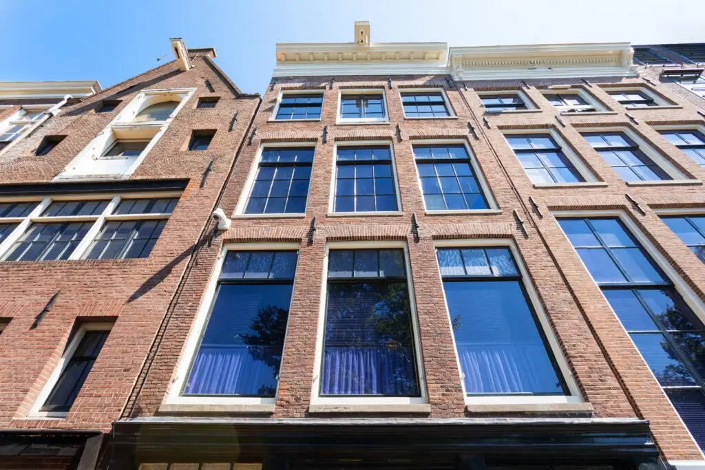 Historic exterior of the Anne Frank House Museum in Amsterdam Netherlands showcasing traditional Dutch brick architecture and large reflective windows