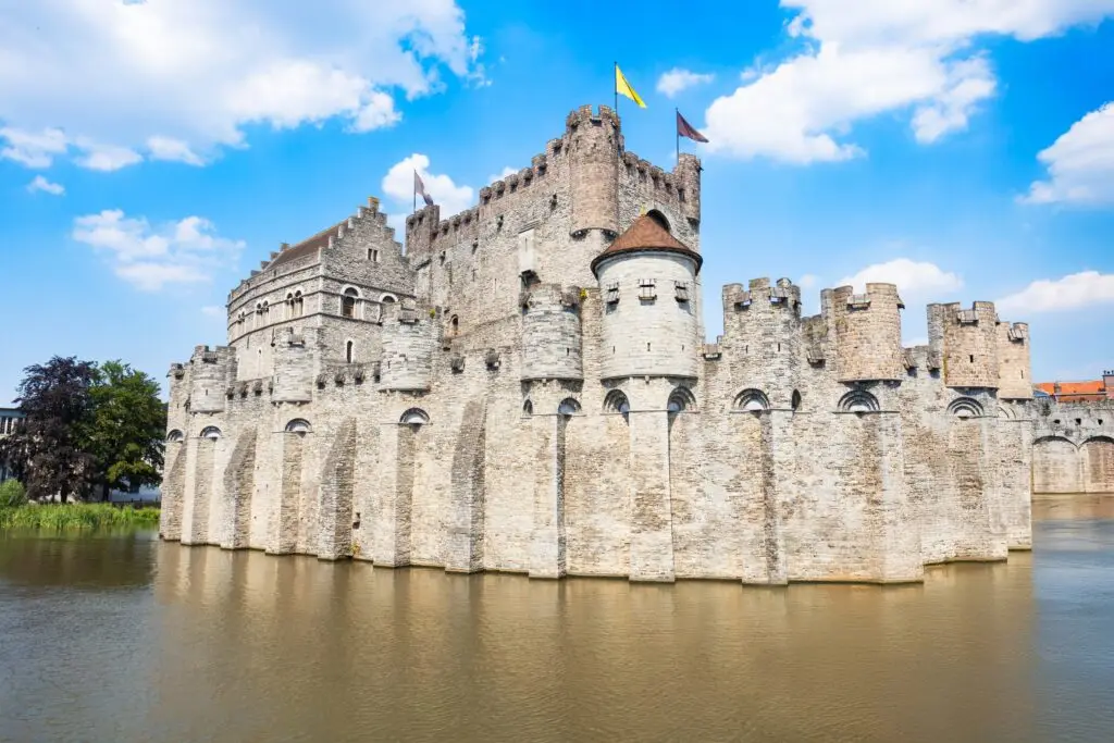 Medieval Gravensteen Castle surrounded by water in Ghent, Belgium, a popular historic attraction for Europe private tours