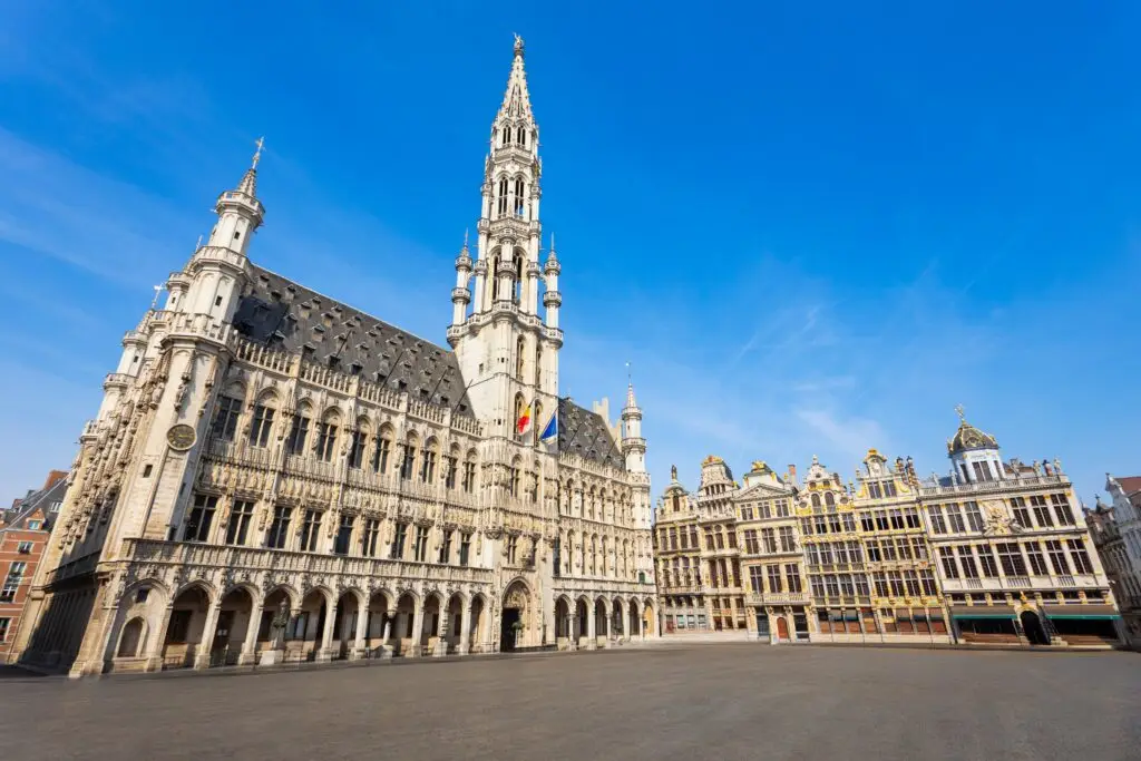 Grand Place Brussels Belgium city square with historic guildhalls and Town Hall under blue sky, popular tourist attraction and UNESCO World Heritage site
