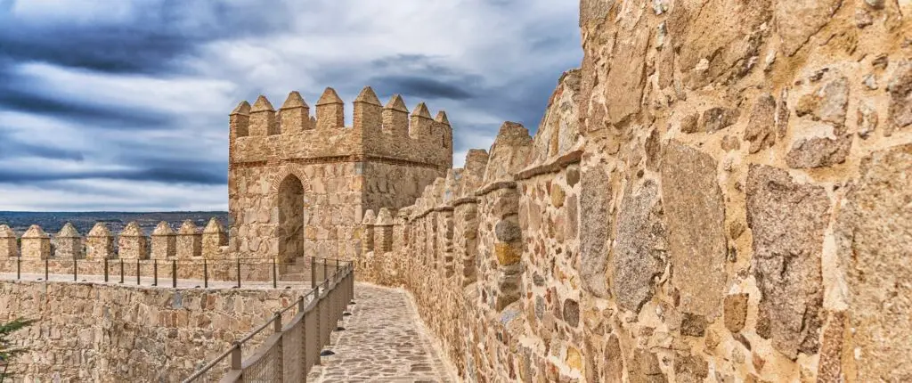 Medieval Walls of Ávila Spain UNESCO World Heritage Site ancient stone fortifications with towers and battlements under dramatic sky