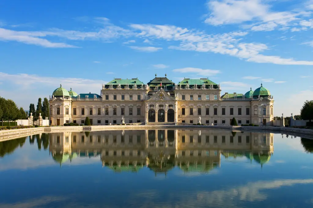 Belvedere Palace in Vienna Austria reflecting in a calm pond under a bright summer sky