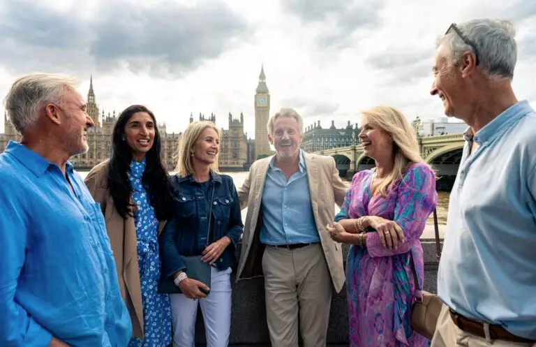 Group of older friends enjoying a private guided tour in London near Big Ben and the Houses of Parliament