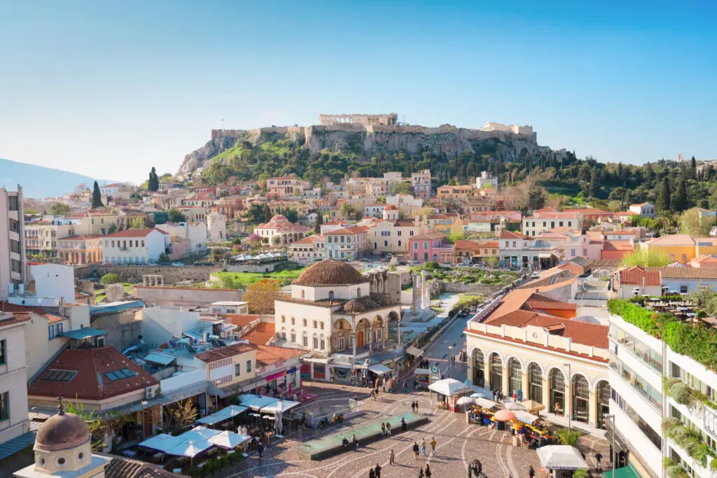 View of Monastiraki Square and the Acropolis in Athens, Greece, with colorful historic buildings and lively streets popular with tourists