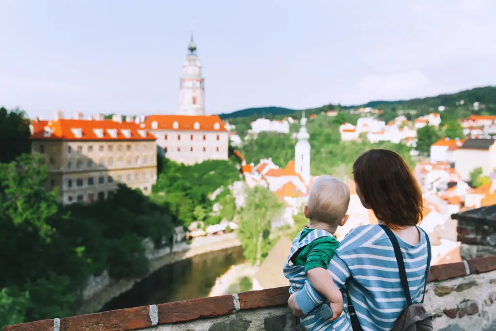 Family of tourists enjoying panoramic view of Cesky Krumlov castle and old town in the Czech Republic during a European private tour